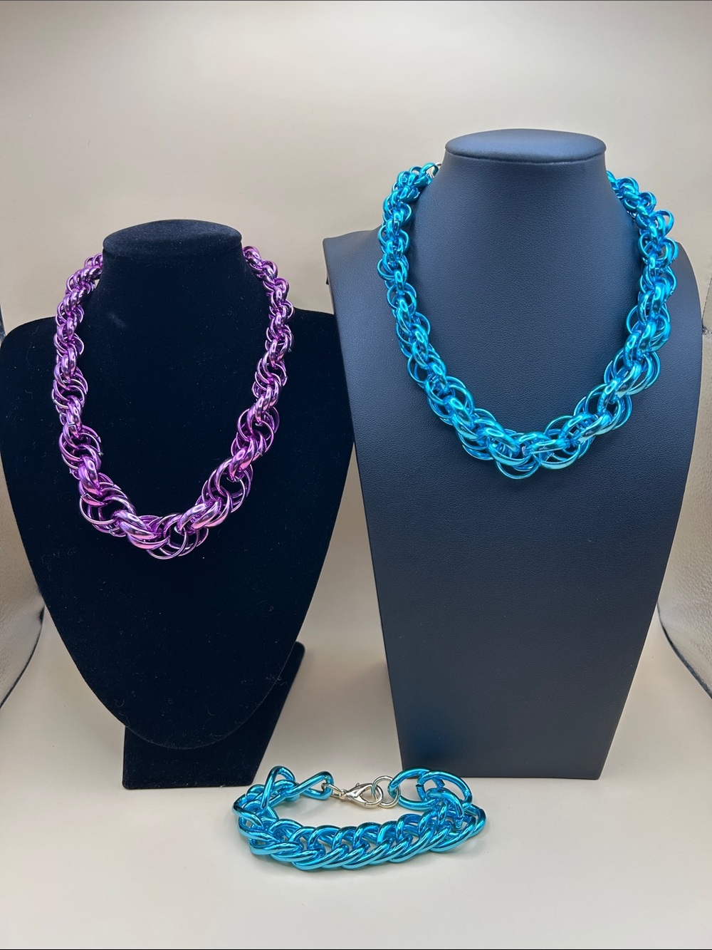 Lightweight metallic metal necklace and bracelet bundle in purple and blue.